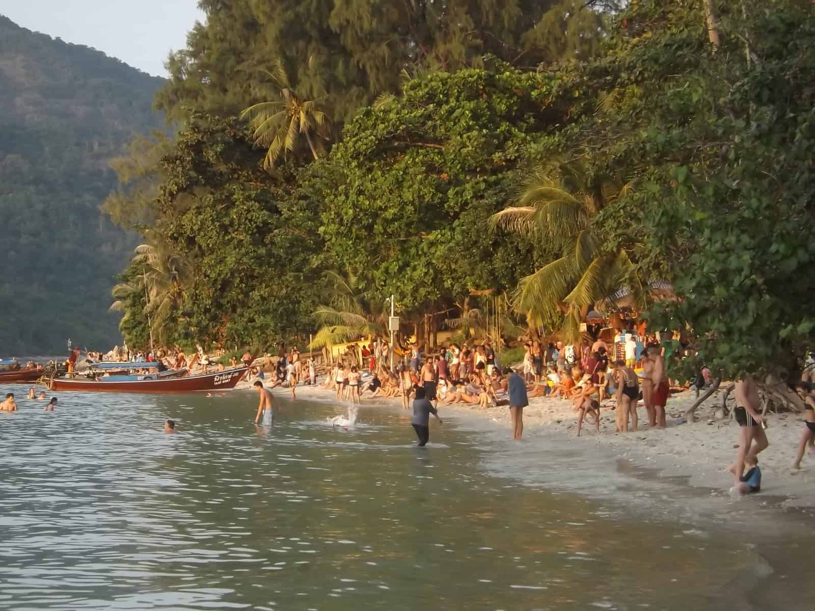 Tourists flocking to the beach to catch a sunset in Koh Lipe // Travel Mermaid