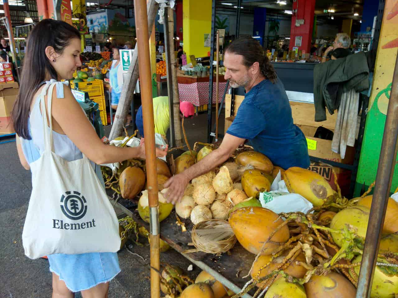 Buying a fresh coconut at Rustys Market in Cairns, Australia // Travel Mermaid