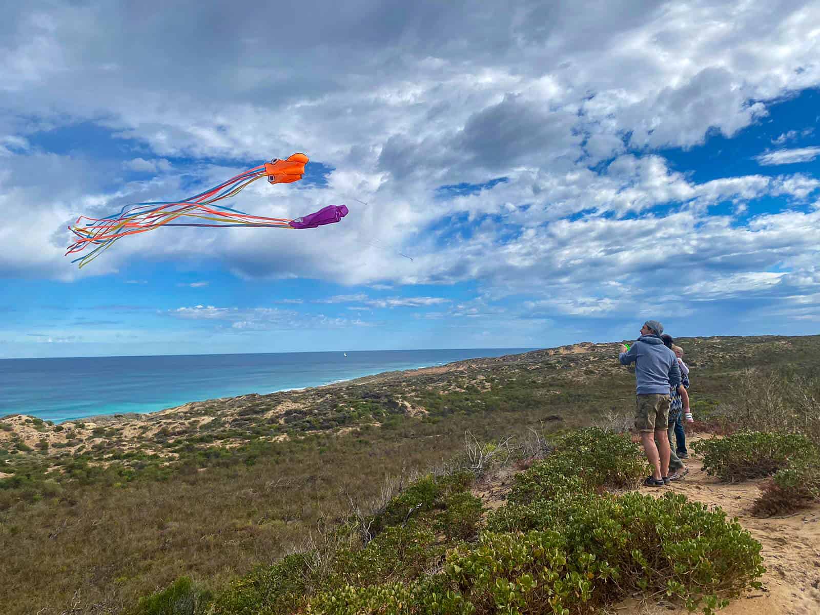 Flying a kite on the sand dunes in Greenough, Western Australia