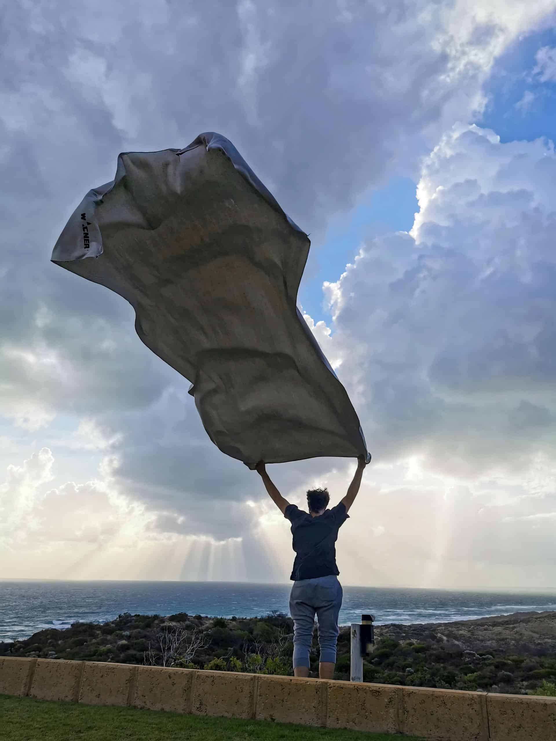 Shaking the drop sheet in windy Greenough, at The Glass House WA